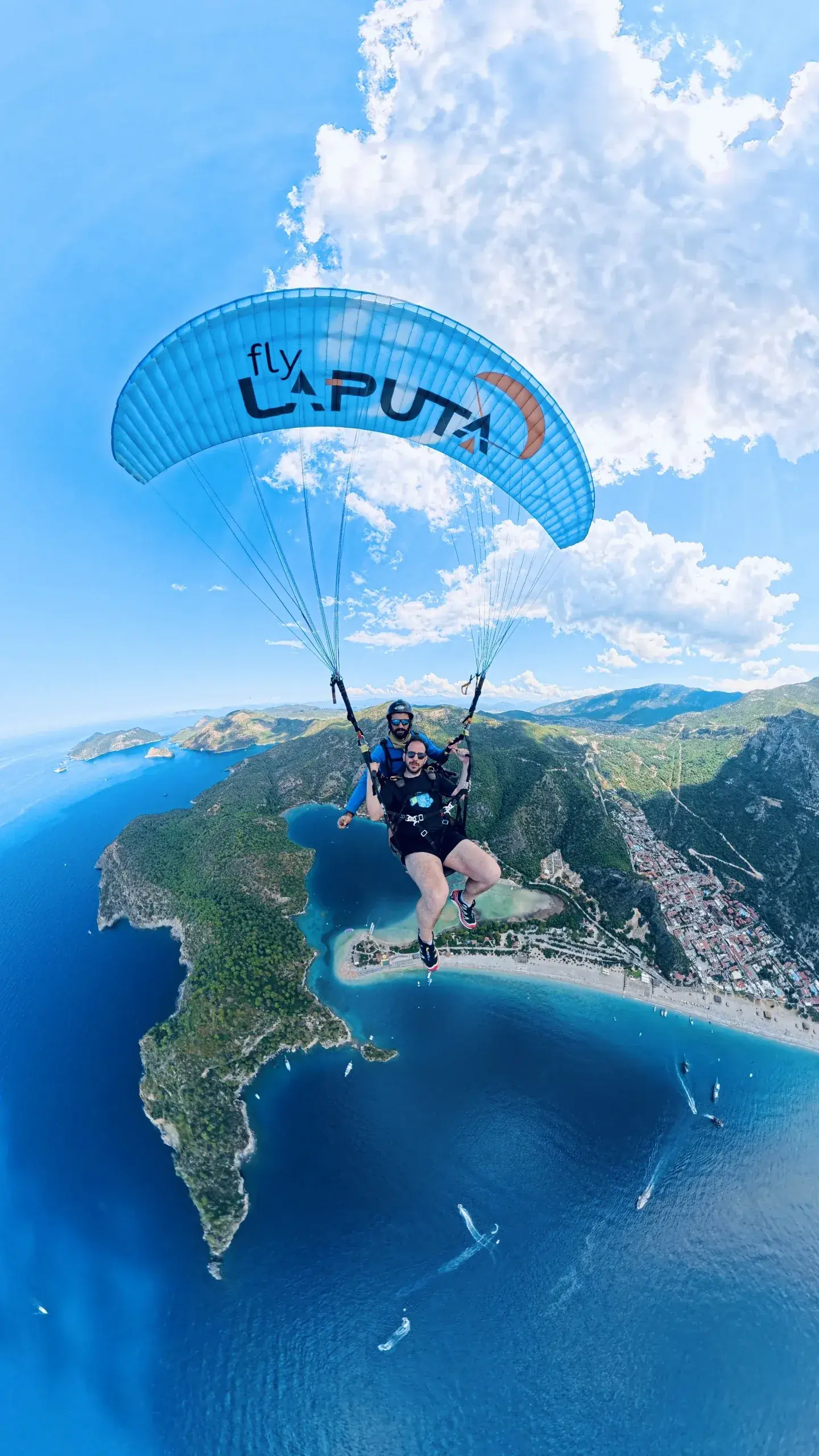 Fly Laputa Paragliding – Fethiye Ölüdeniz Babadağ tandem yamaç paraşütü uçuşu; arka planda mavi lagün ve Akdeniz manzarası
